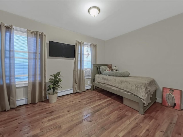 2677 Heath Ave, Bronx, NY 10463 - bedroom with light wood-type flooring and a baseboard heating unit