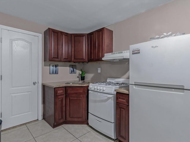 2677 Heath Ave, Bronx, NY 10463 - kitchen featuring white appliances, under cabinet range hood, light tile patterned flooring, and light countertops