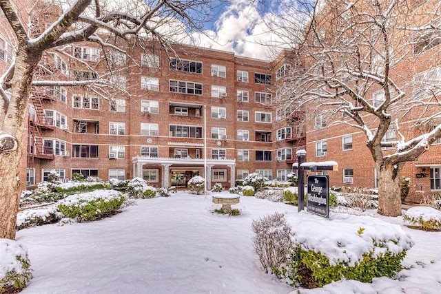 67-66 108th St Unit A58, Forest Hills, NY 11375 - snow covered building featuring a view of apartment building / complex