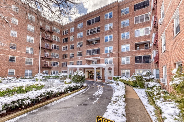 67-66 108th St Unit A58, Forest Hills, NY 11375 - snow covered building with a view of apartment building / complex and cooling unit