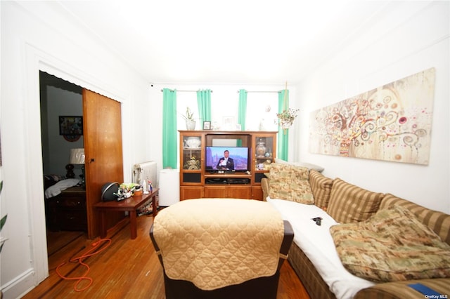 40-45 99th St, Corona, NY 11368 - living area with wood finished floors and radiator heating unit