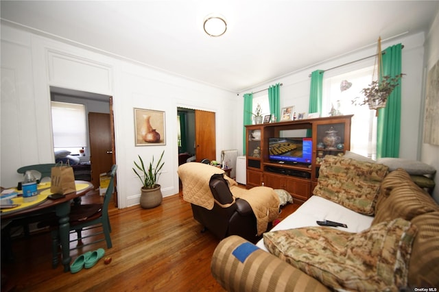 40-45 99th St, Corona, NY 11368 - living area with wood finished floors and radiator heating unit