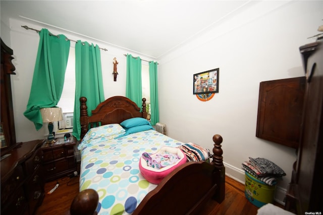 40-45 99th St, Corona, NY 11368 - bedroom featuring wood finished floors and radiator heating unit