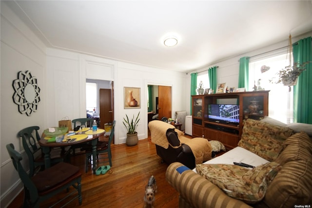 40-45 99th St, Corona, NY 11368 - living area featuring wood finished floors and a decorative wall
