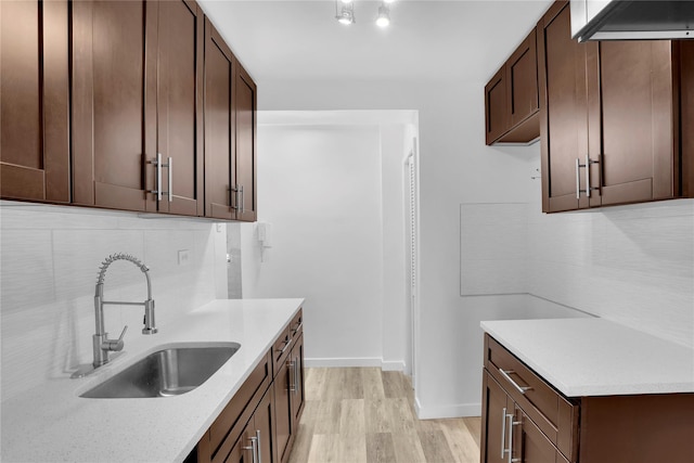 3184 Grand Unit 6D, Bronx, NY 10458 - kitchen with decorative backsplash, light wood-style flooring, light countertops, and dark brown cabinetry