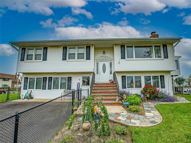 510 S Great Neck Rd, Copiague, NY 11726 - view of front of house with a gate and a chimney