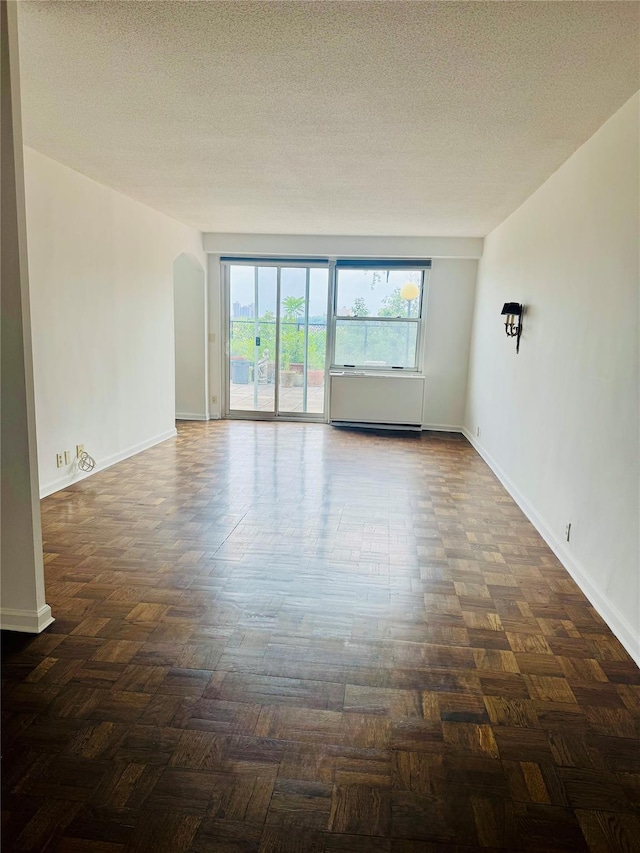 2400 Johnson Ave Unit 1K, Bronx, NY 10463 - spare room featuring arched walkways and a textured ceiling