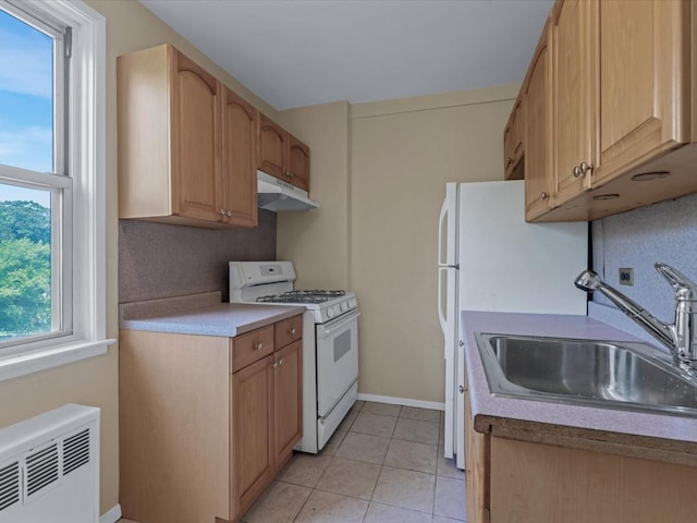 5500 Fieldstone Unit 4Ii, Bronx, NY 10471 - kitchen with white gas range oven, under cabinet range hood, radiator, light tile patterned floors, and light countertops