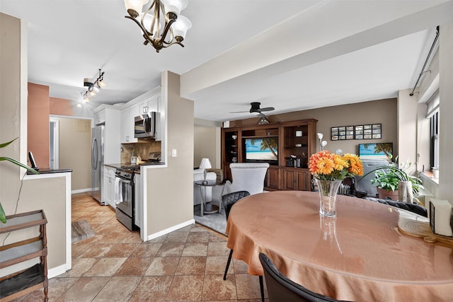 505 Central Ave Unit 408, White Plains, NY 10606 - dining space featuring ceiling fan, light stone finish flooring, a chandelier, and track lighting