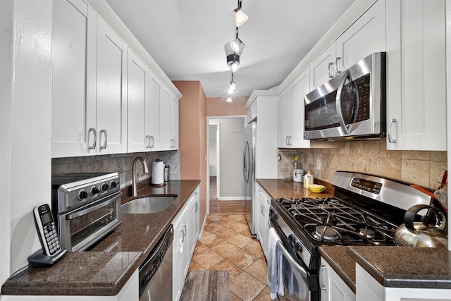 505 Central Ave Unit 408, White Plains, NY 10606 - kitchen with appliances with stainless steel finishes, white cabinetry, decorative backsplash, and dark stone countertops