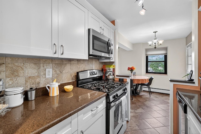 505 Central Ave Unit 408, White Plains, NY 10606 - kitchen featuring stainless steel appliances, a baseboard radiator, tasteful backsplash, white cabinetry, and a chandelier
