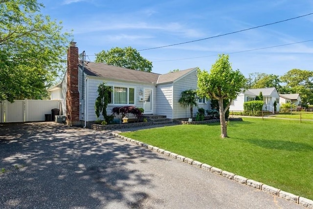118 Pine Neck Ave, East Patchogue, NY 11772 - ranch-style house with asphalt driveway and a chimney