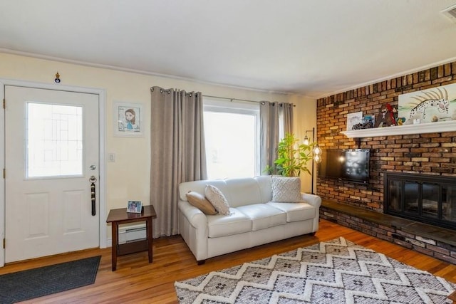 118 Pine Neck Ave, East Patchogue, NY 11772 - living room featuring light wood-type flooring and a brick fireplace
