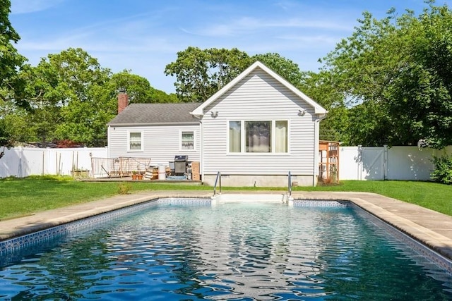 118 Pine Neck Ave, East Patchogue, NY 11772 - back of property with a chimney, a fenced backyard, and a gate