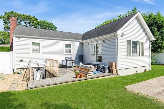 118 Pine Neck Ave, East Patchogue, NY 11772 - rear view of house with a patio, a chimney, a yard, crawl space, and roof with shingles