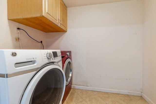 118 Pine Neck Ave, East Patchogue, NY 11772 - laundry room featuring cabinet space, washing machine and dryer, and light tile patterned floors