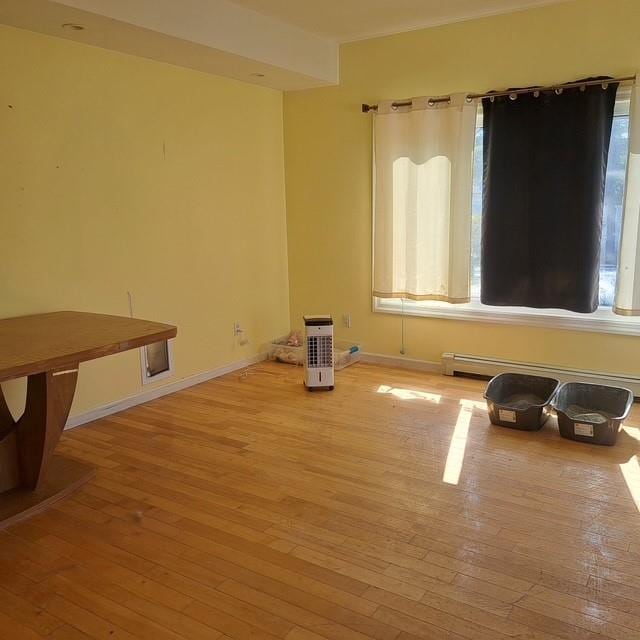 118 Pine Neck Ave, East Patchogue, NY 11772 - spare room featuring light wood-style flooring and a baseboard heating unit