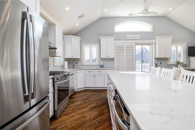 87 Arizona Ave, Long Beach, NY 11561 - kitchen featuring stainless steel appliances, light stone countertops, white cabinetry, dark wood-style floors, and recessed lighting