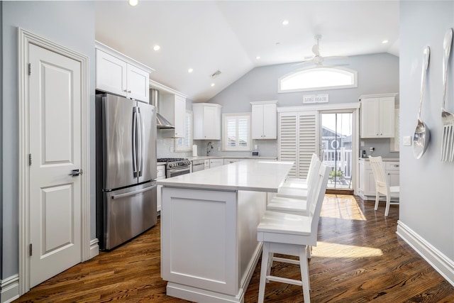 87 Arizona Ave, Long Beach, NY 11561 - kitchen with appliances with stainless steel finishes, wall chimney range hood, white cabinets, a center island, and light countertops