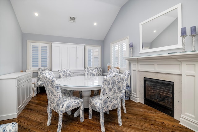 87 Arizona Ave, Long Beach, NY 11561 - dining space featuring vaulted ceiling, dark wood-style flooring, recessed lighting, and a high end fireplace