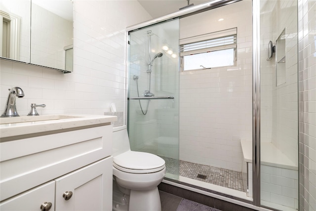 87 Arizona Ave, Long Beach, NY 11561 - bathroom with a shower stall, vanity, and tile walls