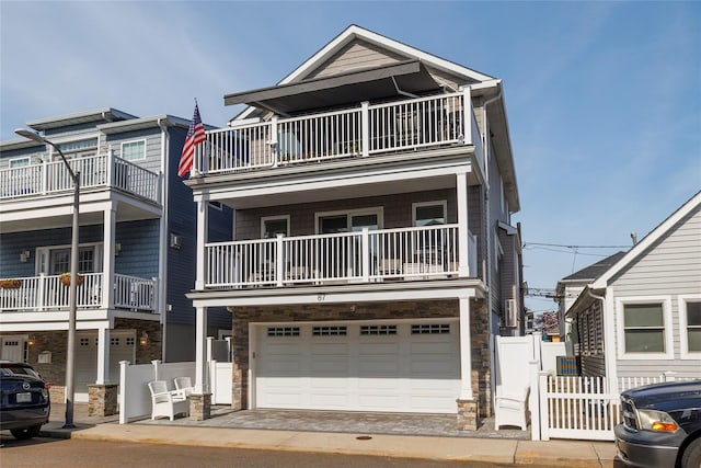 87 Arizona Ave, Long Beach, NY 11561 - multi unit property with stone siding, a balcony, and an attached garage
