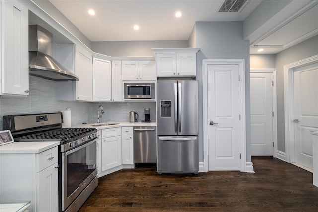87 Arizona Ave, Long Beach, NY 11561 - kitchen with appliances with stainless steel finishes, wall chimney range hood, white cabinetry, light countertops, and recessed lighting