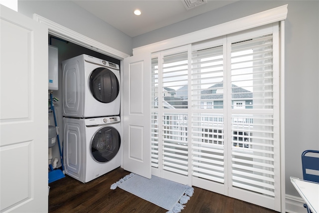 87 Arizona Ave, Long Beach, NY 11561 - laundry area featuring stacked washing machine and dryer, dark wood finished floors, recessed lighting, and water heater