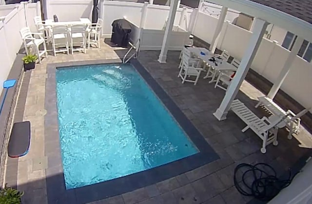 87 Arizona Ave, Long Beach, NY 11561 - swimming pool featuring outdoor dining space, a patio, and a fenced backyard