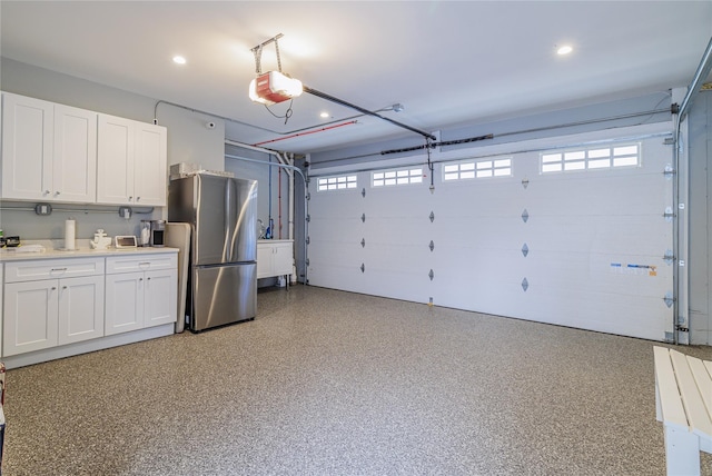 87 Arizona Ave, Long Beach, NY 11561 - garage with freestanding refrigerator, a garage door opener, and recessed lighting