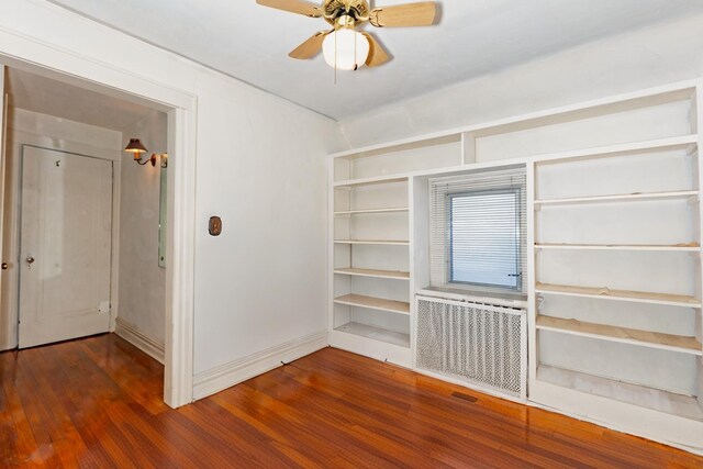 136 Sturges St, Staten Island, NY 10314 - spare room with wood finished floors, a ceiling fan, and radiator