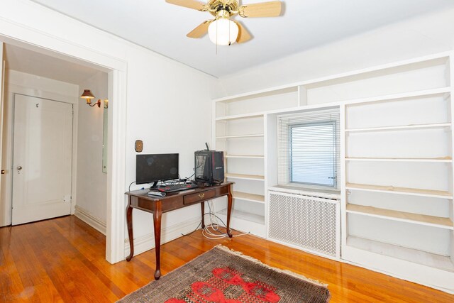 136 Sturges St, Staten Island, NY 10314 - home office featuring radiator heating unit, wood finished floors, and a ceiling fan