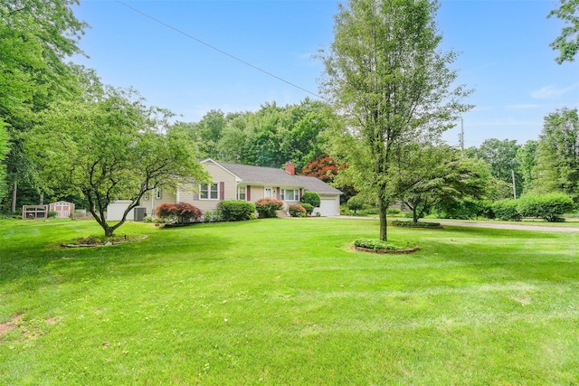 63 Lake Walton Rd, Wappingers Falls, NY 12590 - view of front of home featuring a chimney, a front yard, an attached garage, and a shed