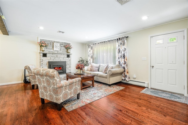63 Lake Walton Rd, Wappingers Falls, NY 12590 - living room with baseboard heating, wood finished floors, a stone fireplace, and recessed lighting
