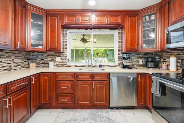 63 Lake Walton Rd, Wappingers Falls, NY 12590 - kitchen featuring appliances with stainless steel finishes, reddish brown cabinets, light tile patterned floors, light countertops, and tasteful backsplash