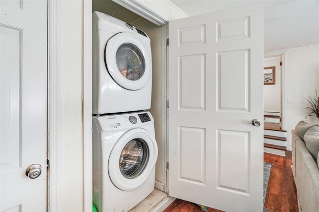 63 Lake Walton Rd, Wappingers Falls, NY 12590 - laundry area featuring estacked washer and dryer, wood finished floors, and a baseboard radiator