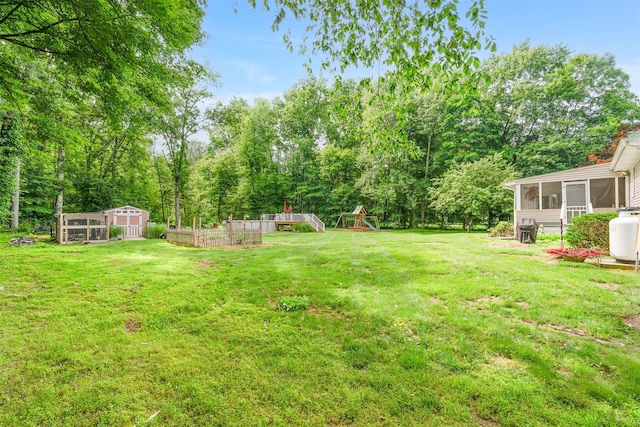 63 Lake Walton Rd, Wappingers Falls, NY 12590 - view of grassy yard featuring a sunroom, a playground, and a storage unit