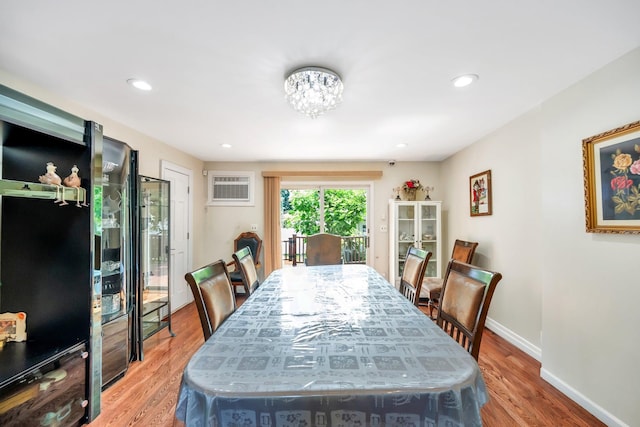 118 Grant Ave, Albertson, NY 11507 - dining room with a wall unit AC, light wood finished floors, a chandelier, and recessed lighting