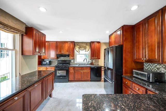 118 Grant Ave, Albertson, NY 11507 - kitchen featuring black appliances, under cabinet range hood, decorative backsplash, dark stone counters, and recessed lighting