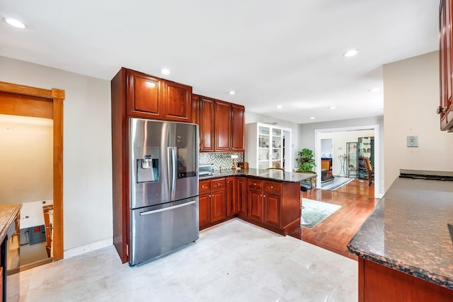 118 Grant Ave, Albertson, NY 11507 - kitchen with stainless steel fridge, a peninsula, recessed lighting, decorative backsplash, and dark stone countertops