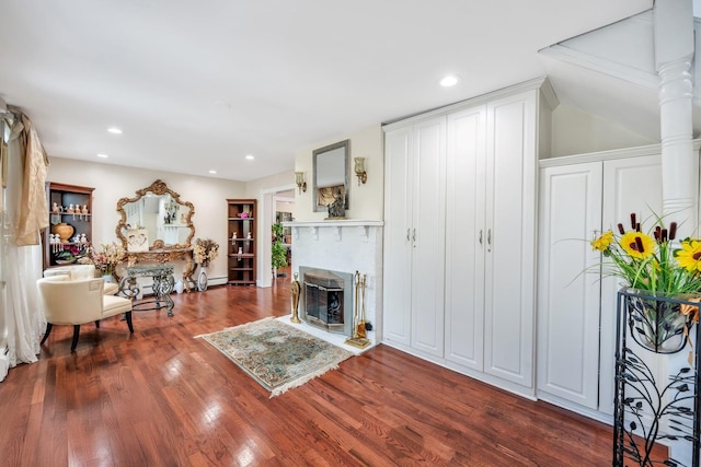 118 Grant Ave, Albertson, NY 11507 - living room featuring wood finished floors, a glass covered fireplace, recessed lighting, and baseboard heating