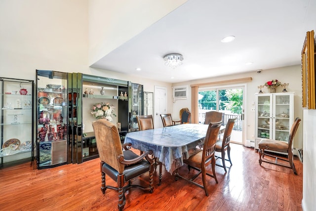 118 Grant Ave, Albertson, NY 11507 - dining room with a wall unit AC, wood finished floors, a baseboard radiator, and recessed lighting