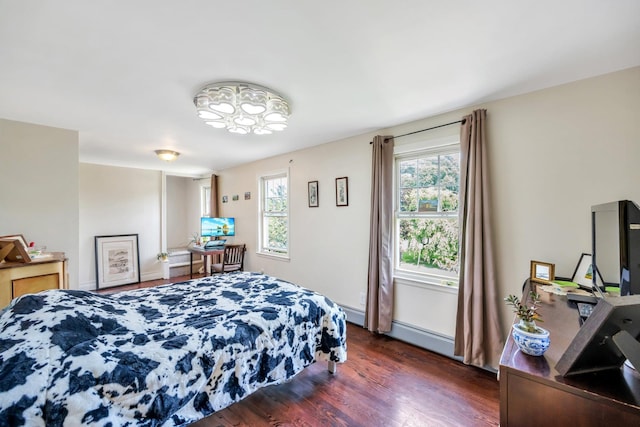 118 Grant Ave, Albertson, NY 11507 - bedroom with wood finished floors and a baseboard radiator