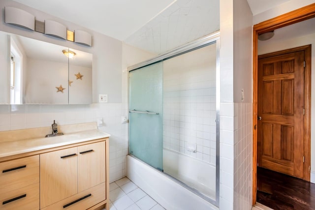 118 Grant Ave, Albertson, NY 11507 - full bath with tile walls, vanity, shower / bath combination with glass door, a wainscoted wall, and tile patterned flooring