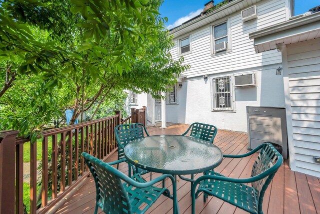 118 Grant Ave, Albertson, NY 11507 - wooden deck featuring outdoor dining area, a wall unit AC, and cooling unit