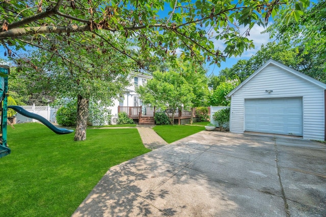 118 Grant Ave, Albertson, NY 11507 - view of grassy yard with a garage, concrete driveway, a playground, an outdoor structure, and a wooden deck