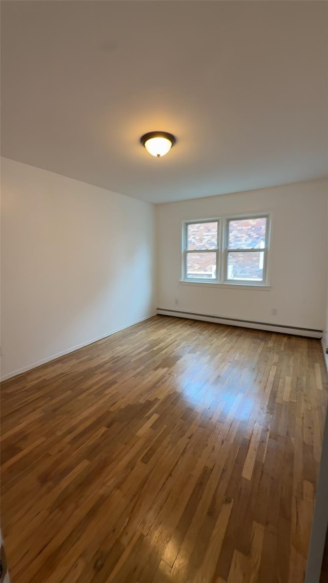 232-04 88th Ave, Queens Village, NY 11427 - spare room with hardwood / wood-style floors and baseboard heating