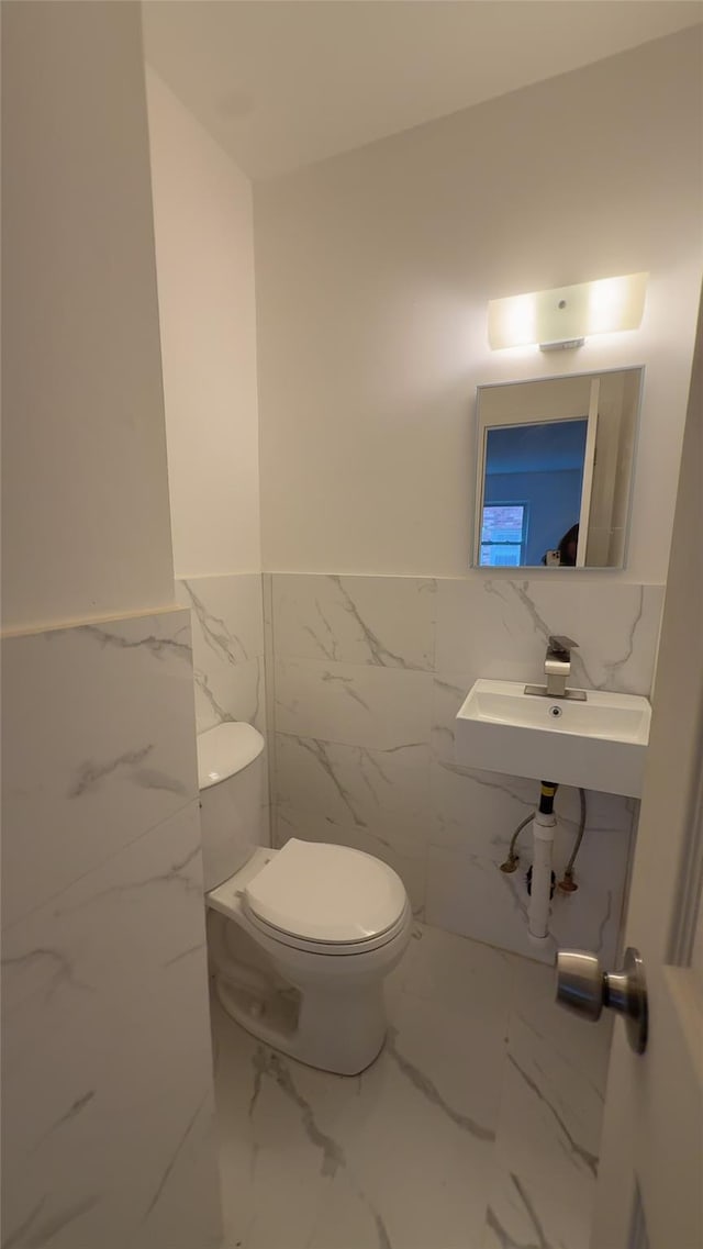 232-04 88th Ave, Queens Village, NY 11427 - bathroom featuring tile walls, a wainscoted wall, and marble finish floors