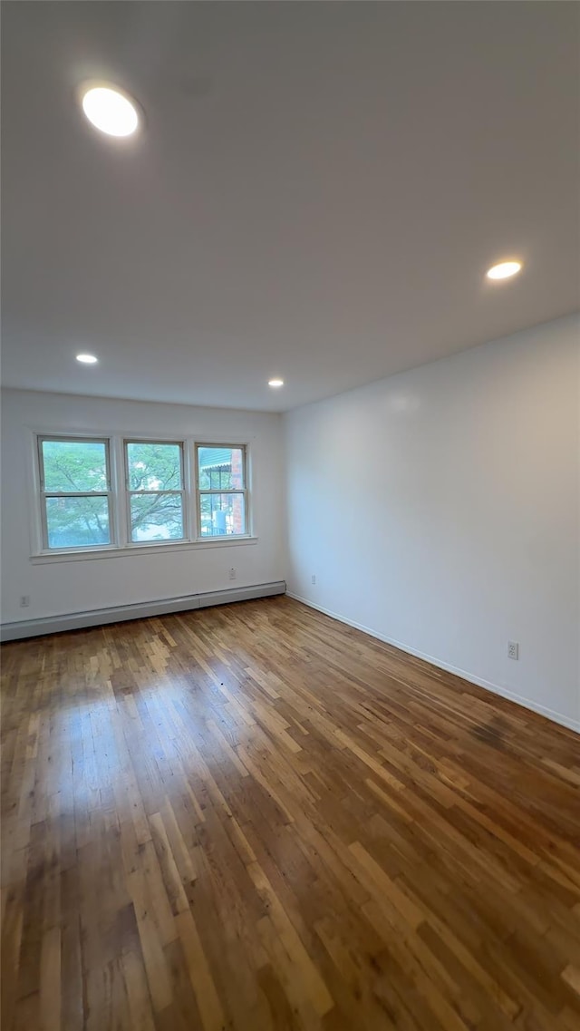 232-04 88th Ave, Queens Village, NY 11427 - spare room featuring healthy amount of natural light, hardwood / wood-style floors, a baseboard radiator, and recessed lighting
