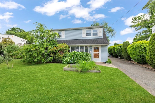 2354 7th St, East Meadow, NY 11554 - view of front facade featuring a front lawn and roof with shingles